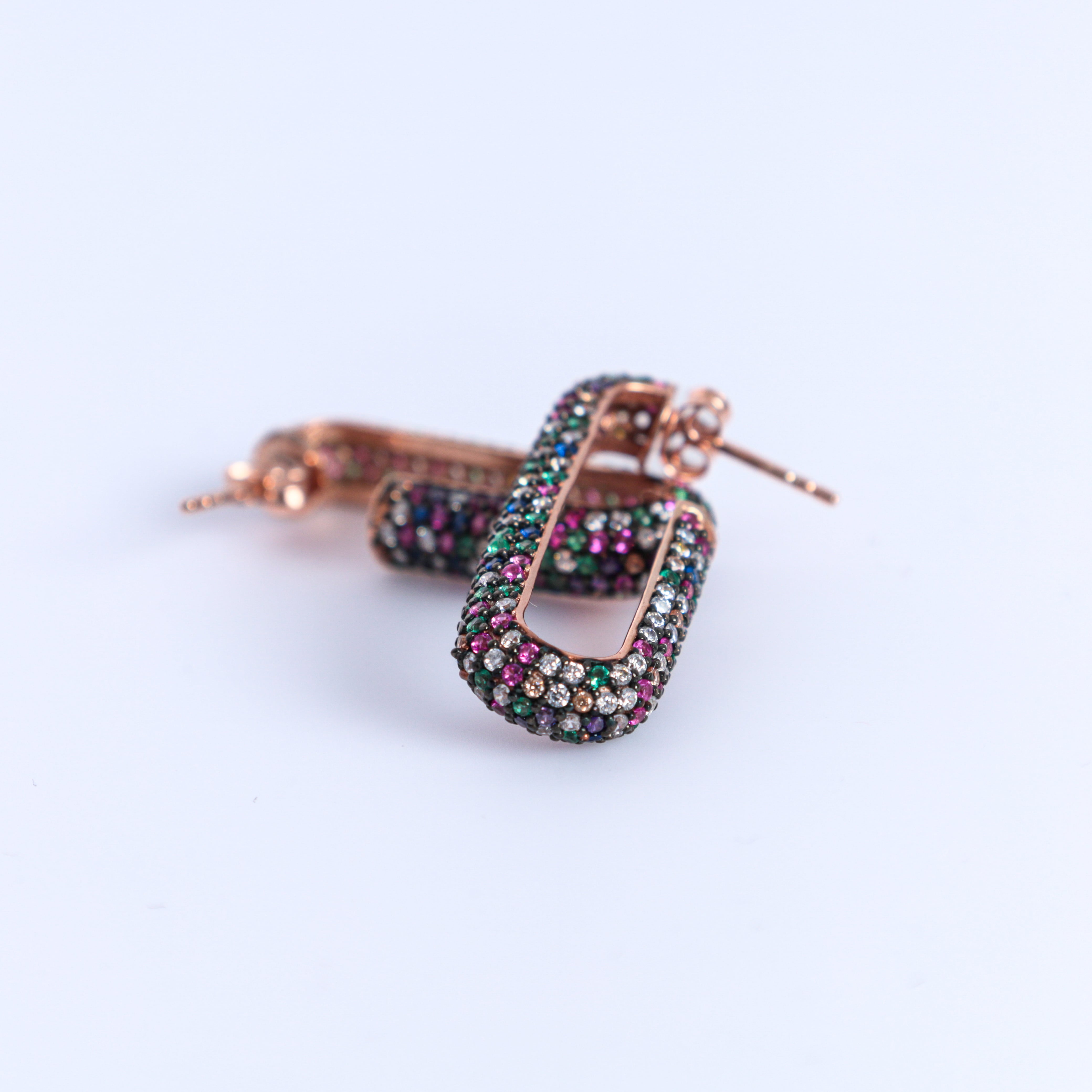 Multicolored hoop earrings on a white background