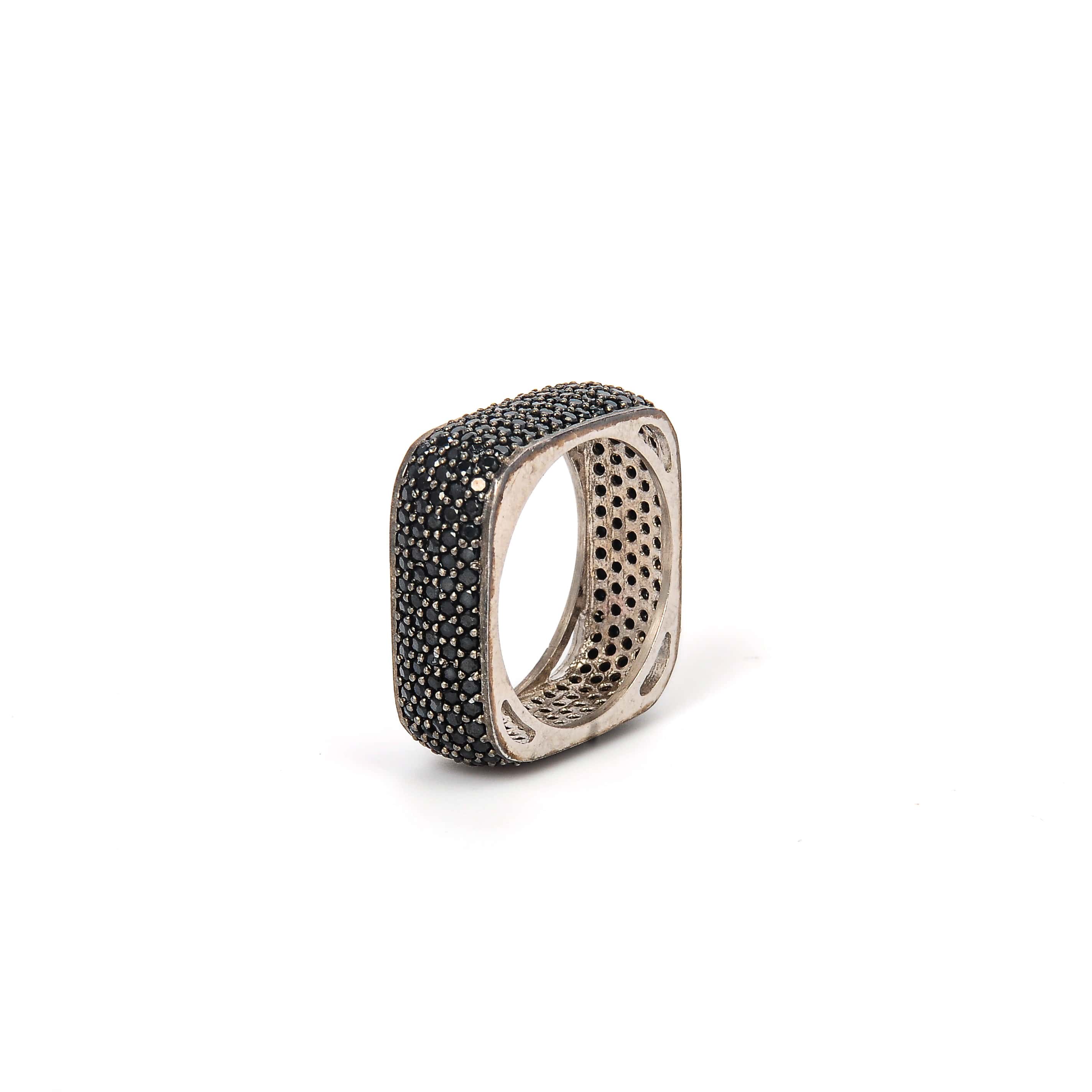 Silver ring with black gemstones on a white background