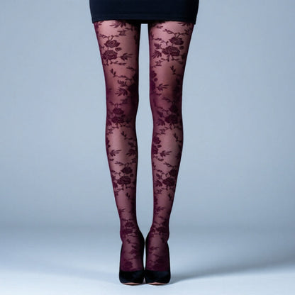 Dark floral-patterned tights worn by a person on a light blue background