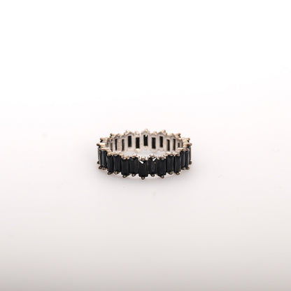 Silver ring with black stones on a white background