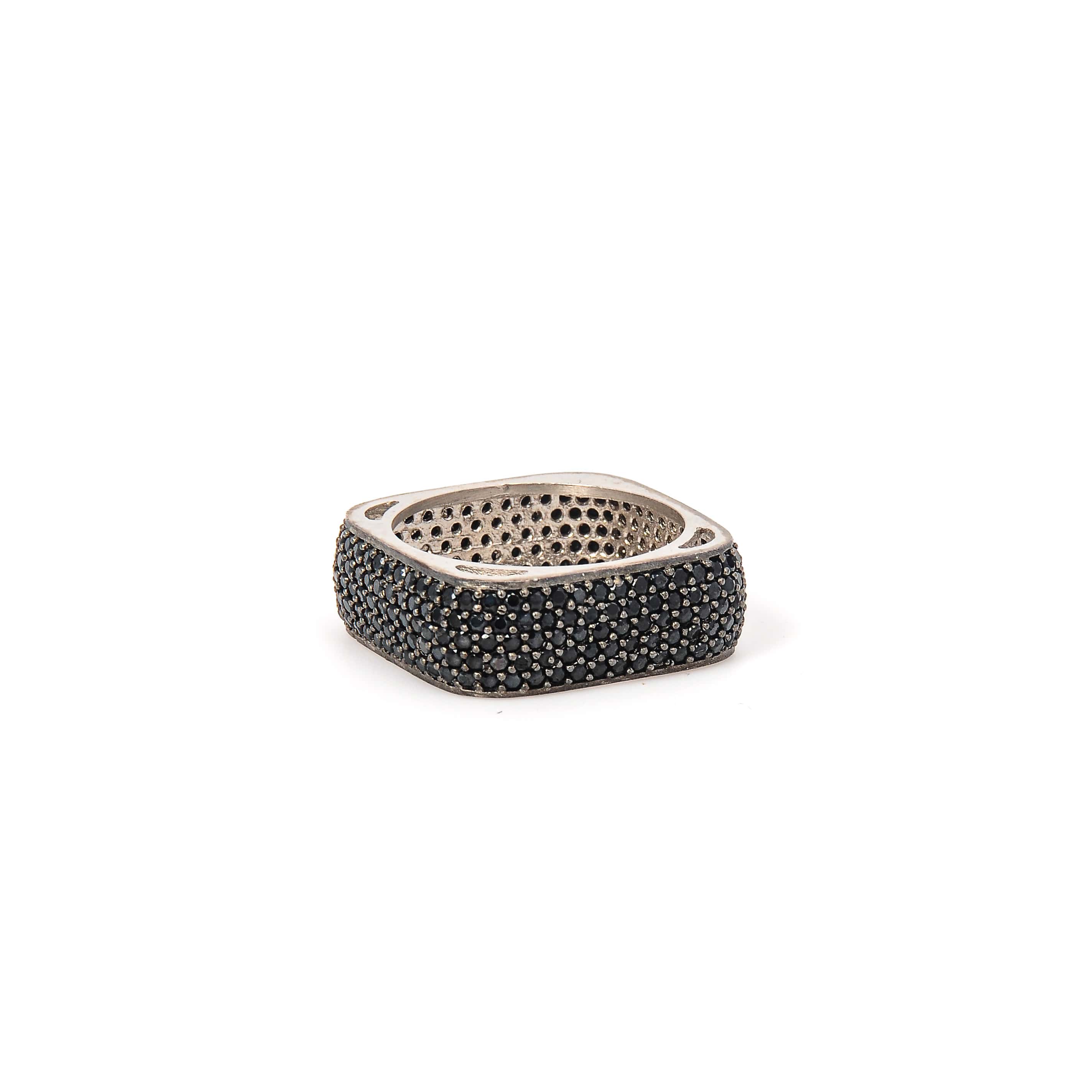 Silver ring with black stones on a white background