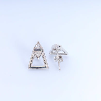 Pair of silver triangle earrings on a light gray background